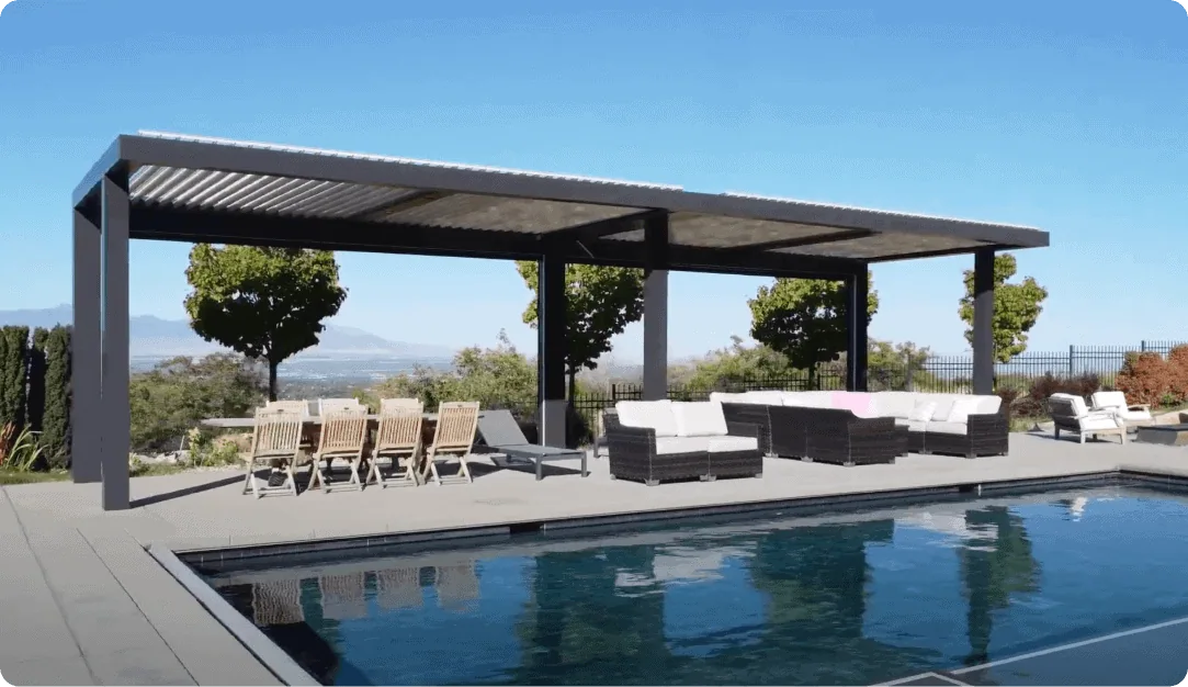 Large black motorized pergola shading a patio beside a pool