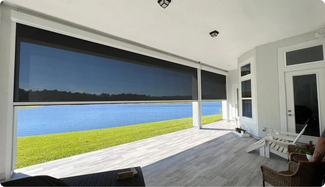 Retractable screen lowered halfway across a covered patio opening